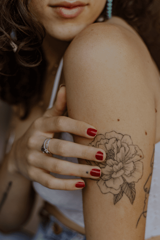 A woman with a japanese flower tattoo.